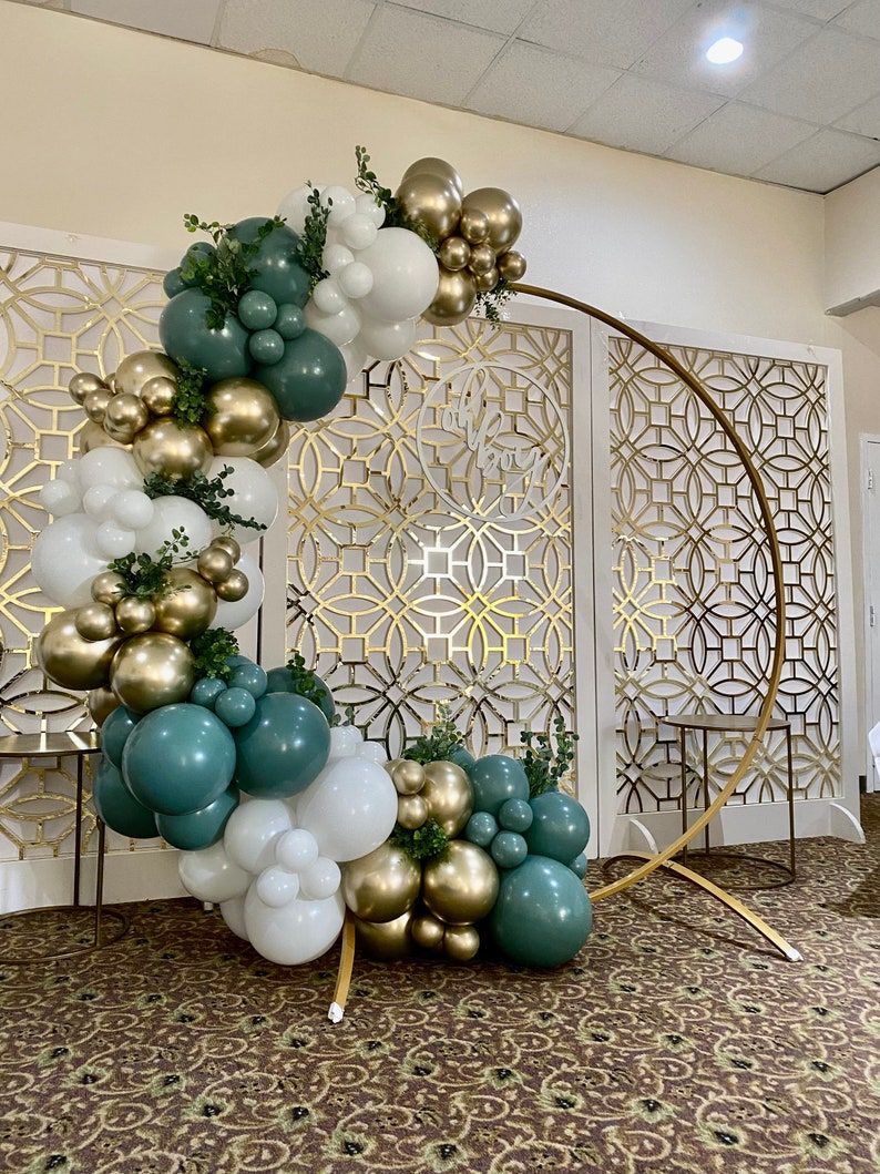 Elegant Green and Gold Balloon Arch with Floral Accents